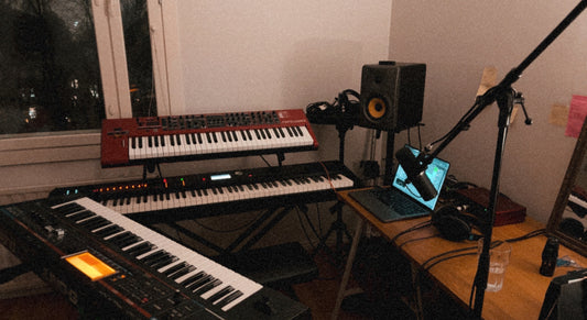 Real photo of a home recording studio setup including microphones and a keyboards