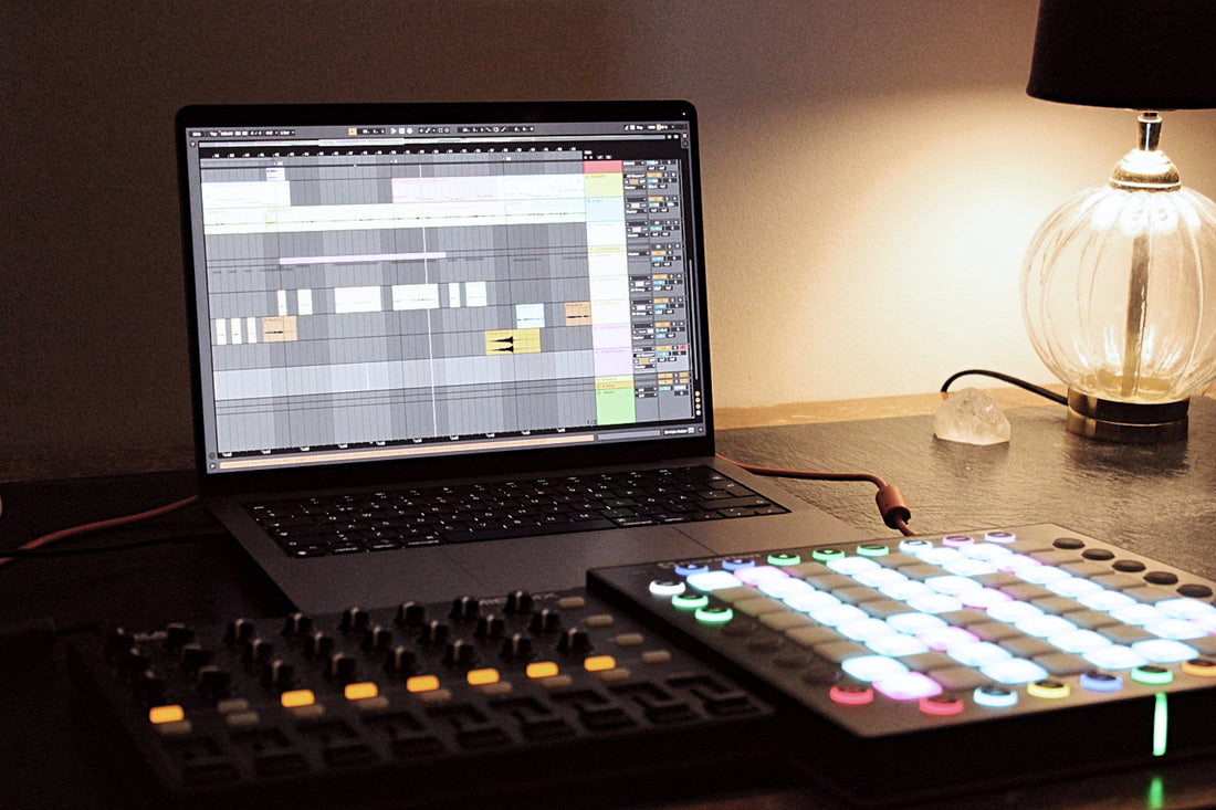 Image of a laptop and two MIDI controllers used in music production