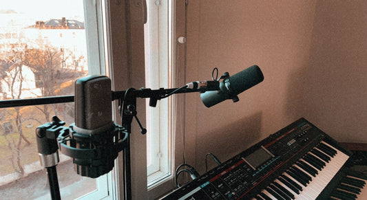 Real photo of two microphones and a keyboard in a home recording studio setup